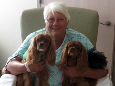 Pet assist therapy dogs, Ozzie and Maiya with a happy patient before being discharged.